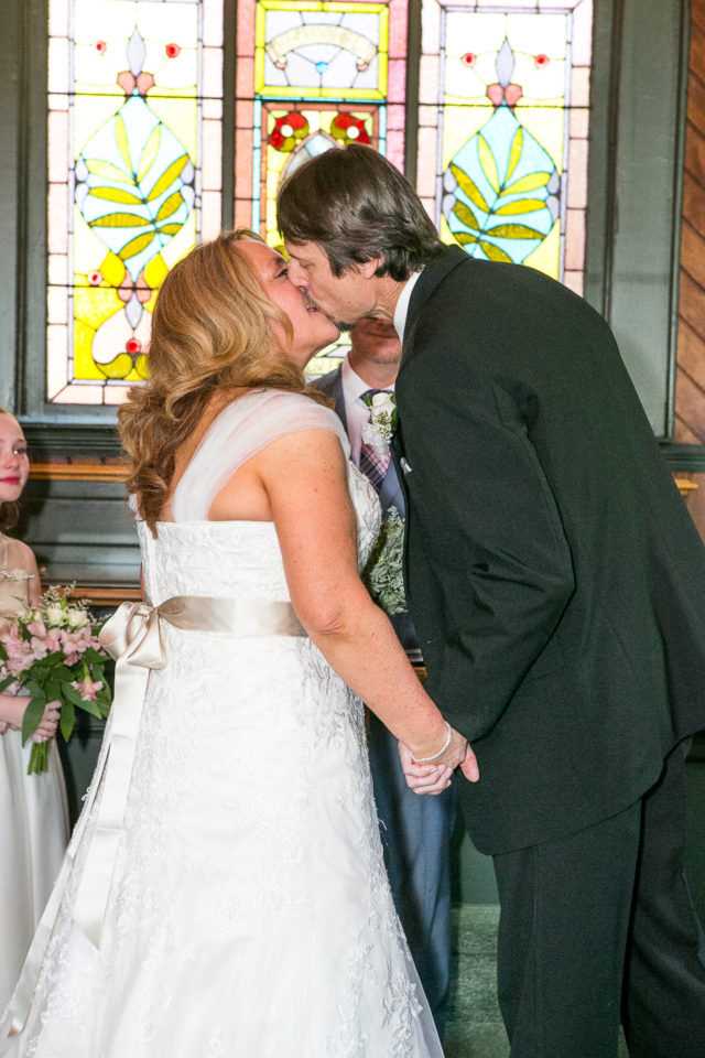 Kathryn and James kiss on their wedding day