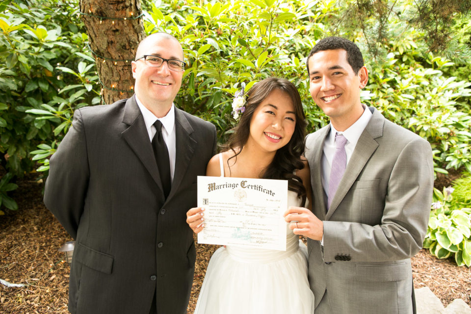 Menghan & Kelsey hold their wedding certificate