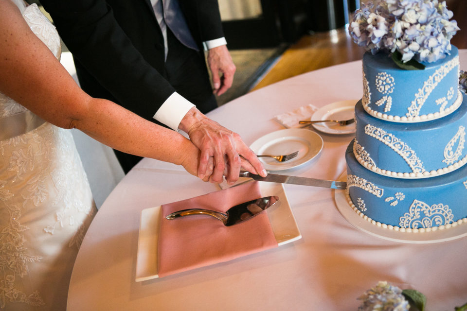 Kathryn and James cut their wedding cake together