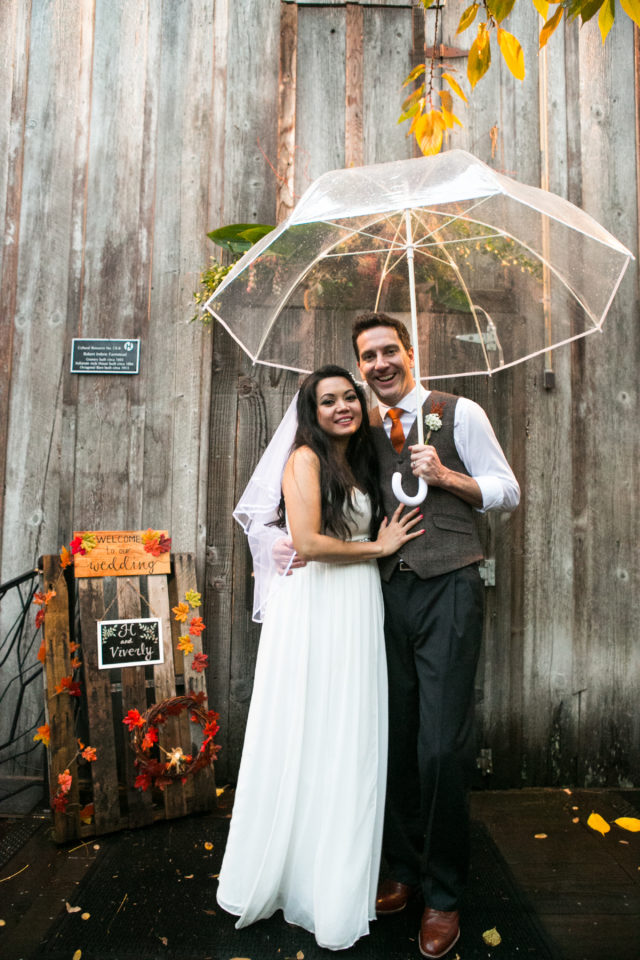 Viv and H stand in front of the Mcmenamins Octagonal Barn on their wedding day