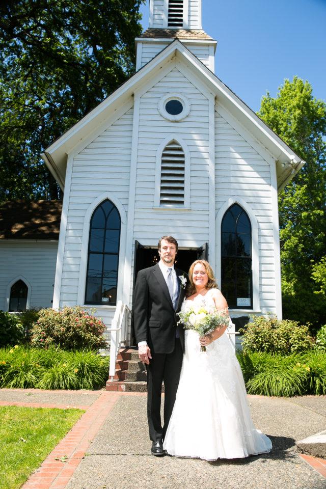 Kathryn and James stand in front of Oaks Sellwood Church